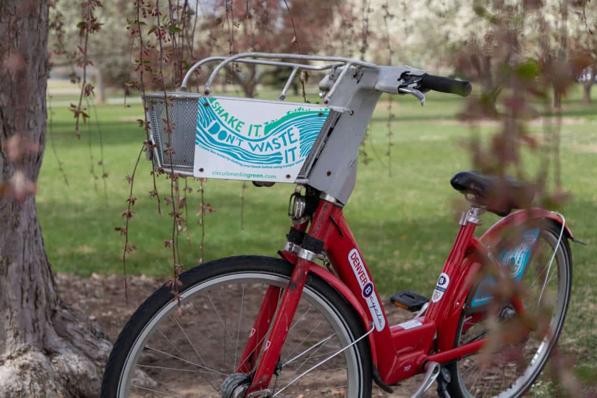 A red B-Cycle with a Circuit Media Green graphic on the basket